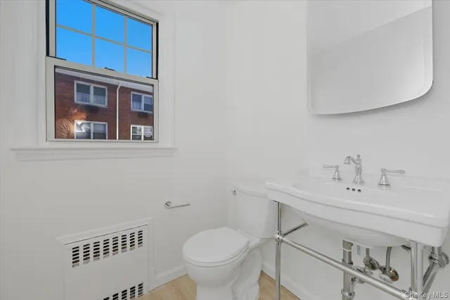 a bathroom with a sink a toilet and mirror