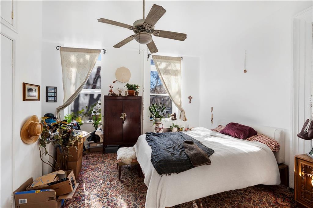 151 Kane Street Brooklyn, NY 11201 - Photo 3 of 14 a bedroom with a bed and a chandelier