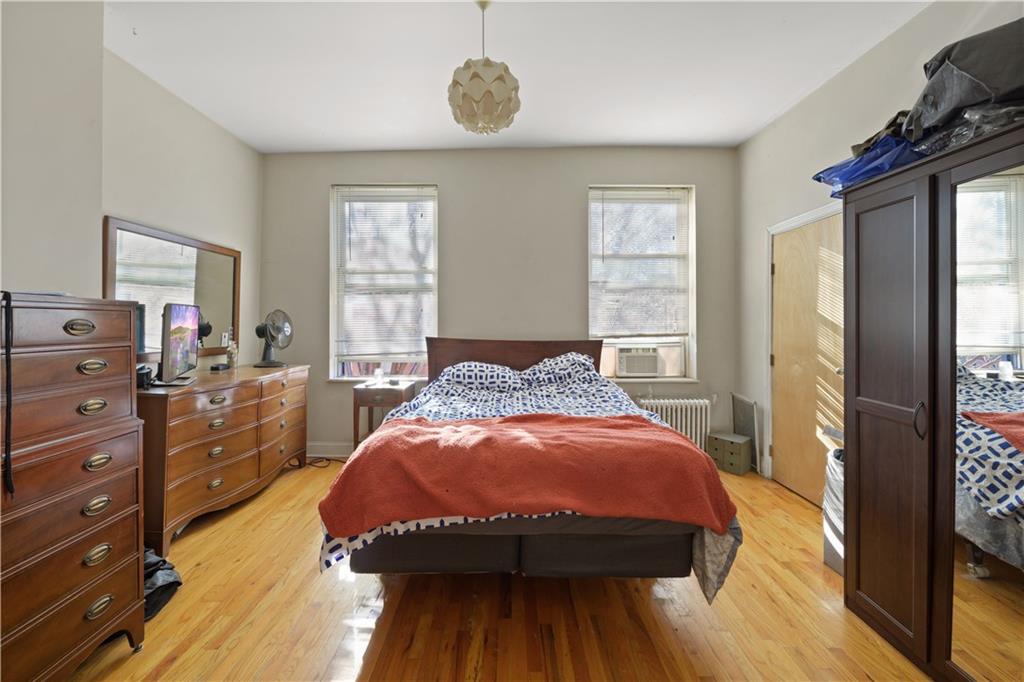 151 Kane Street Brooklyn, NY 11201 - Photo 4 of 14 a bed sitting in a bedroom next to a window