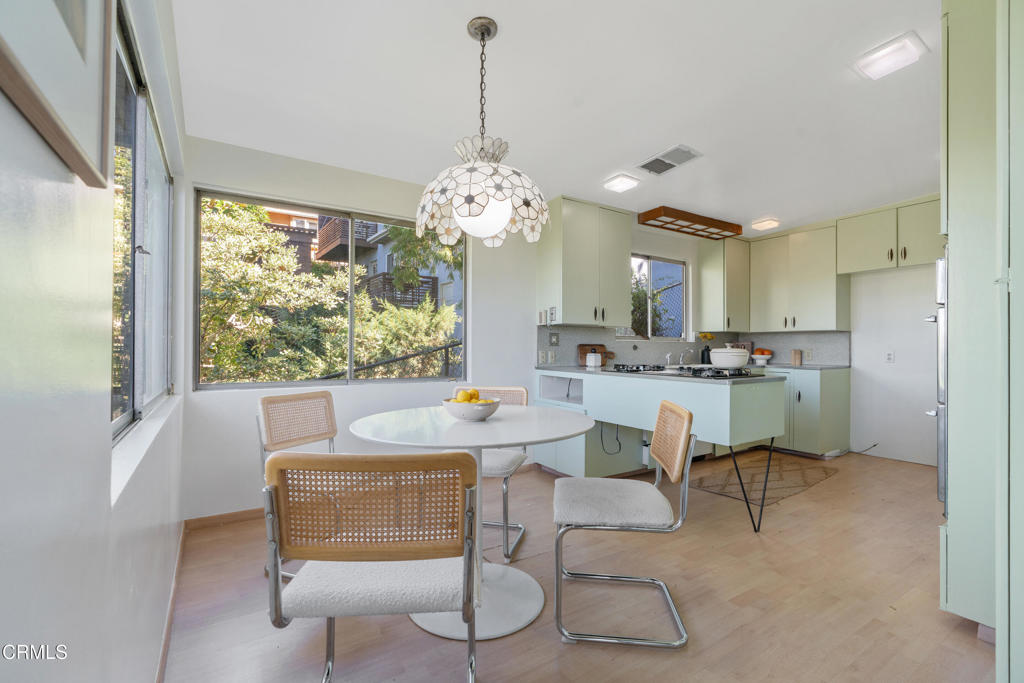 1959 Lucile Avenue Los Angeles, CA 90039 - Photo 16 of 49 a dining room with furniture a chandelier and window