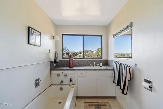 a kitchen with a sink a refrigerator and cabinets