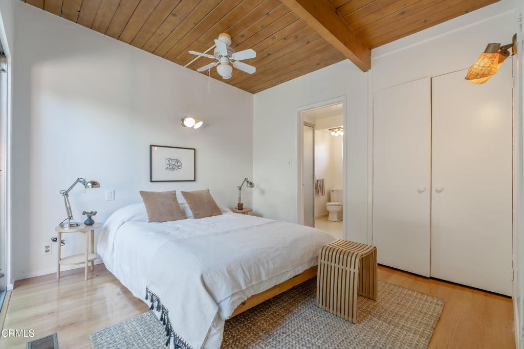 1959 Lucile Avenue Los Angeles, CA 90039 - Photo 26 of 49 a bedroom with a bed and a chandelier
