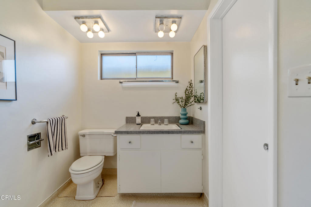 1959 Lucile Avenue Los Angeles, CA 90039 - Photo 27 of 49 a bathroom with a granite countertop toilet sink and mirror