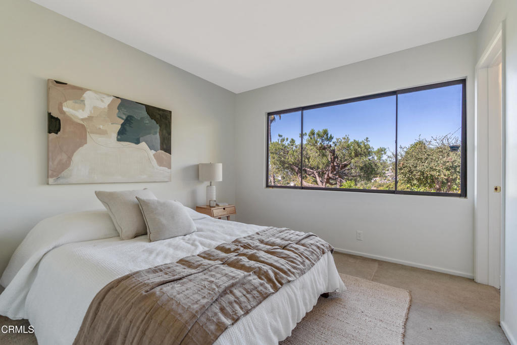 1959 Lucile Avenue Los Angeles, CA 90039 - Photo 30 of 49 a bedroom with a large bed and a painting on the wall