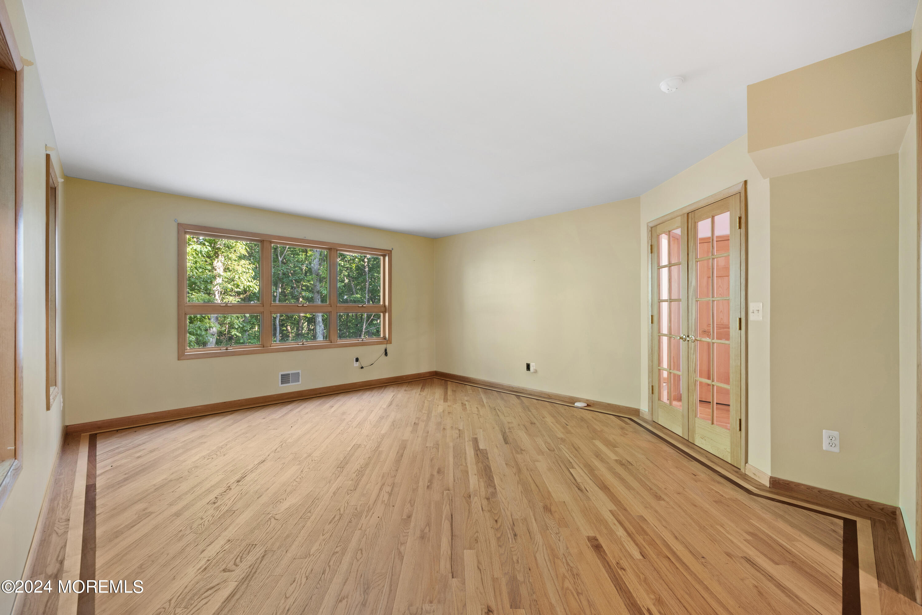 418 Stagecoach Road Millstone Township, NJ 08510 - Photo 15 of 43 a view of an empty room with wooden floor and a window