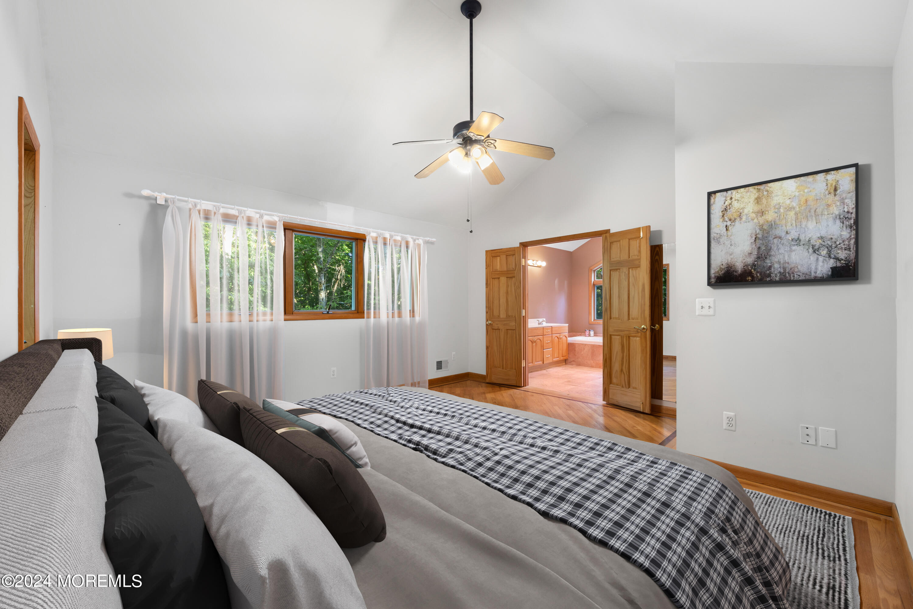 418 Stagecoach Road Millstone Township, NJ 08510 - Photo 16 of 43 a bedroom with a large bed and a chandelier