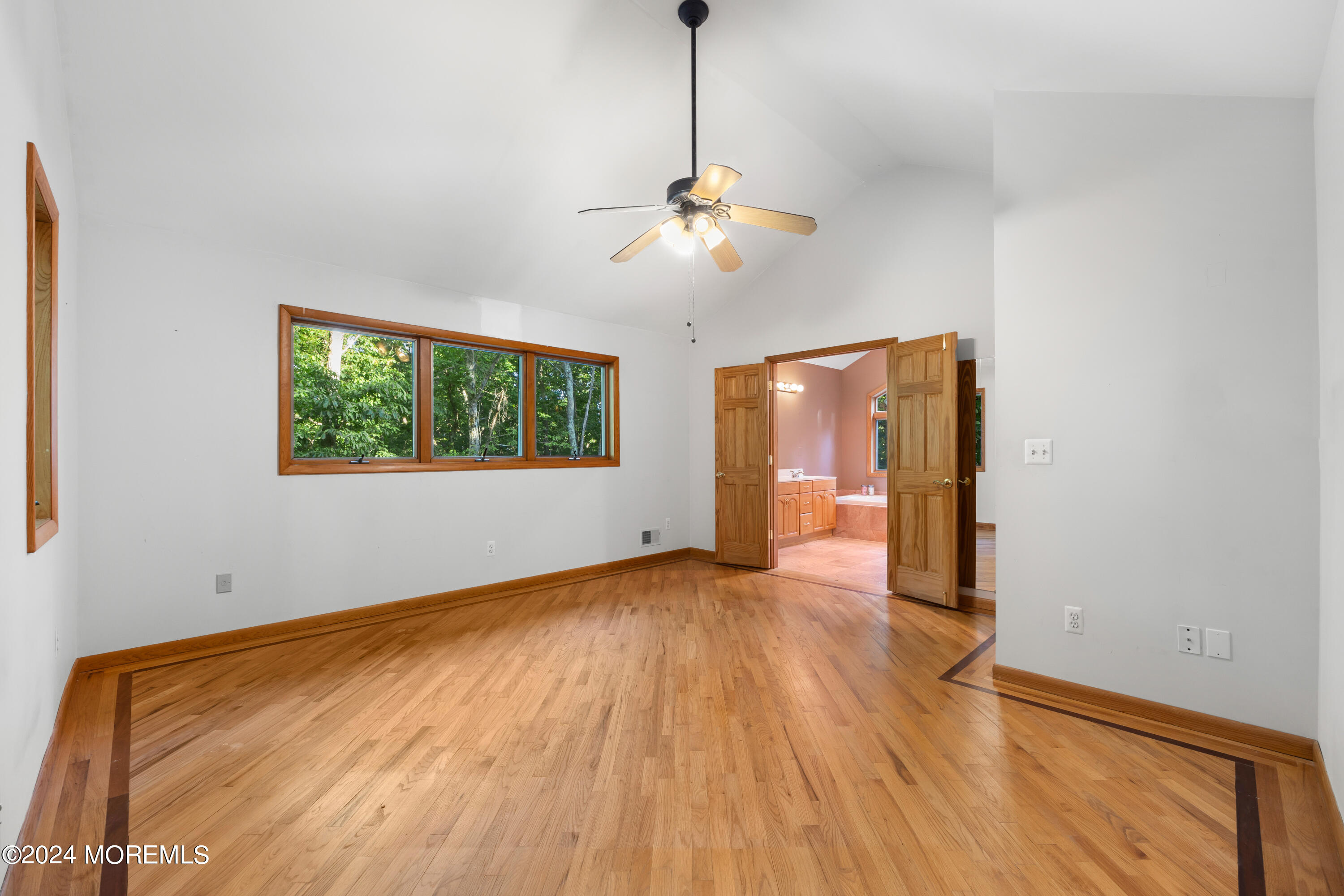 418 Stagecoach Road Millstone Township, NJ 08510 - Photo 17 of 43 a view of an empty room with window and wooden floor