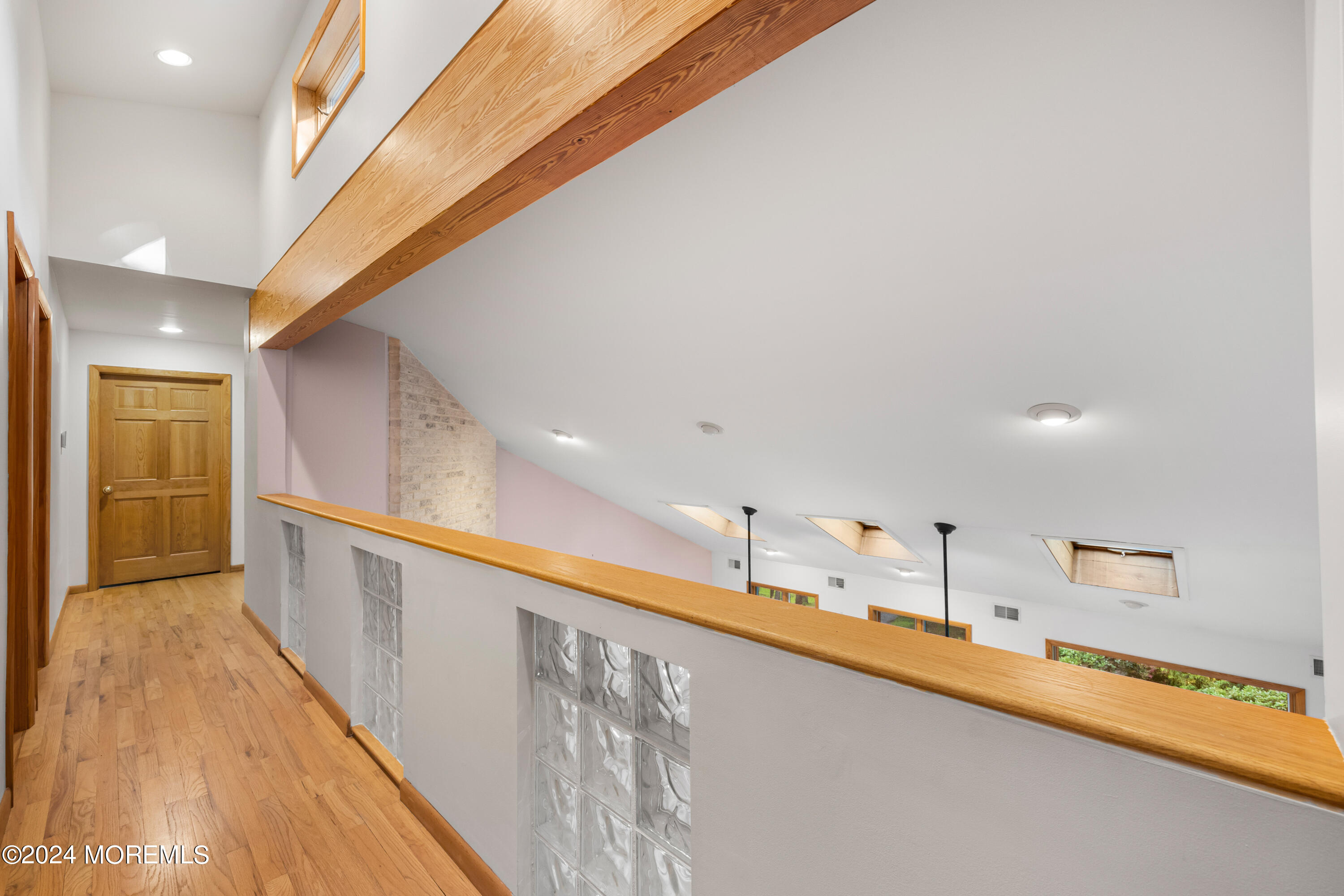 418 Stagecoach Road Millstone Township, NJ 08510 - Photo 24 of 43 a view of a kitchen with kitchen island a sink wooden floor and a glass top table