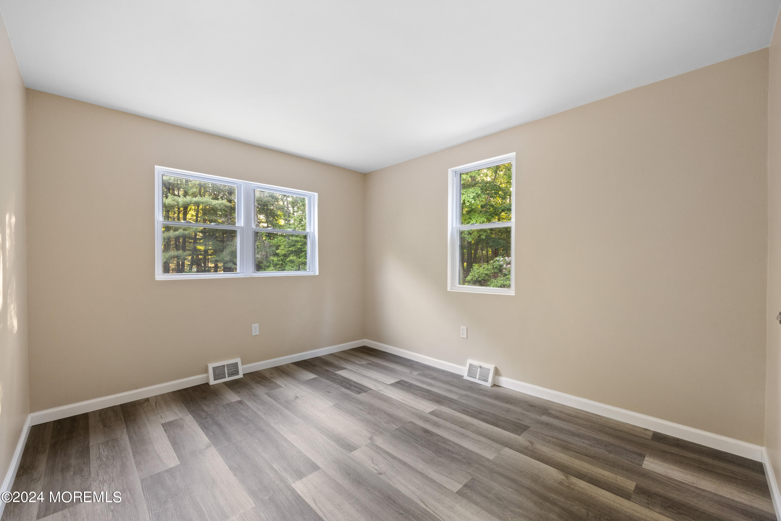 418 Stagecoach Road Millstone Township, NJ 08510 - Photo 34 of 43 an empty room with wooden floor and windows