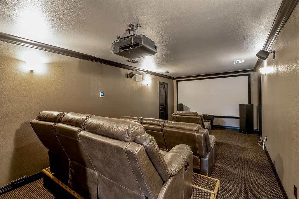 20389 County Road 178 Flint, TX 75762 - Photo 32 of 40 Dedicated media room with tiered seating featuring projector, large screen, and integrated speakers