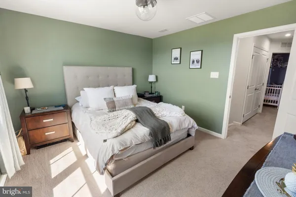 a bedroom with a bed and a dresser