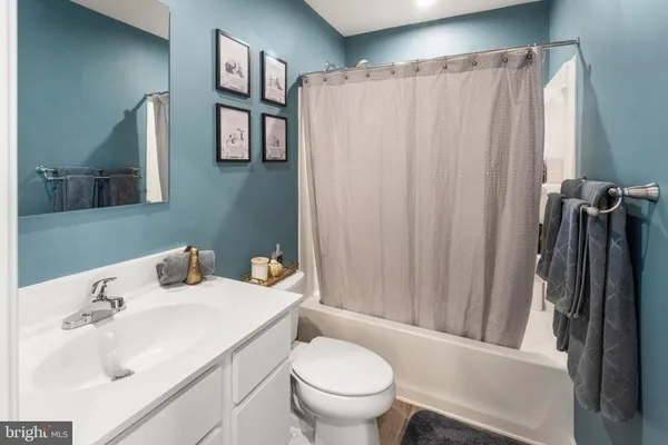 a bathroom with a sink toilet and mirror