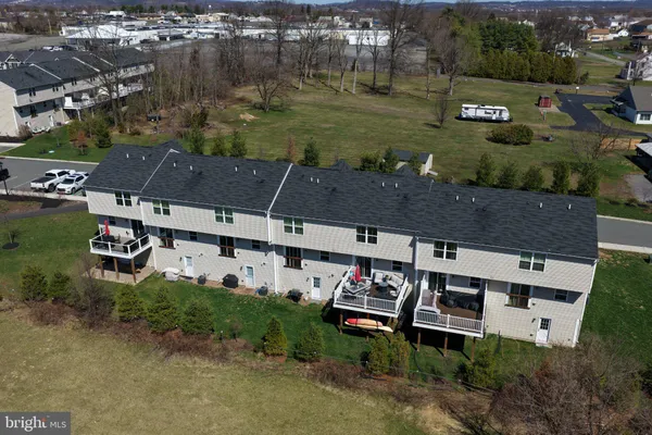 an aerial view of a house with garden space and street view