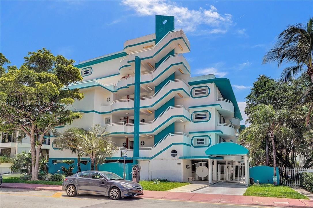 9156 Collins Avenue, Unit 204 Surfside, FL 33154 - Photo 1 of 17 a front view of a building with trees