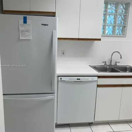 a close view of a refrigerator in kitchen and cabinets