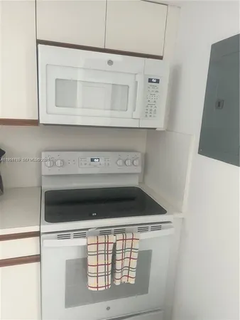 a stove top oven sitting inside of a kitchen
