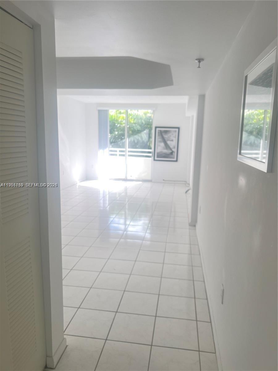 9156 Collins Avenue, Unit 204 Surfside, FL 33154 - Photo 9 of 17 an empty room with an empty space and window
