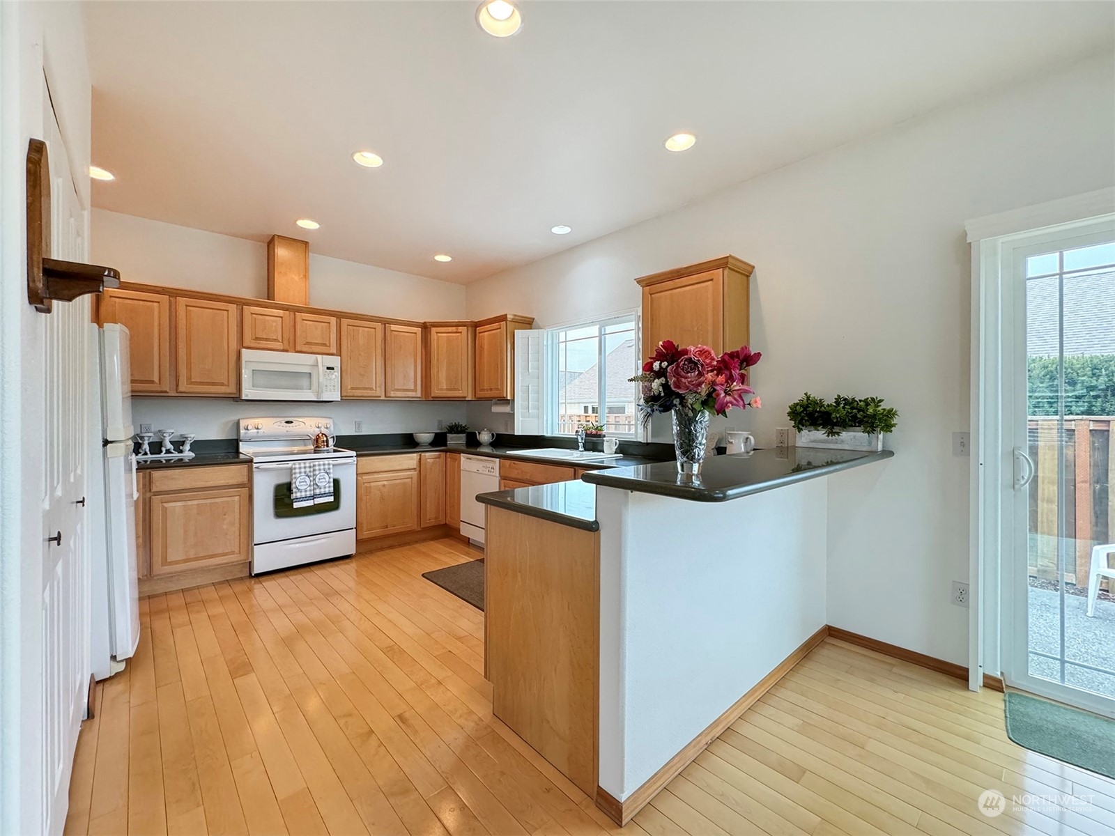50 Nesting Place Sequim, WA 98382 - Photo 11 of 40 a kitchen with stainless steel appliances granite countertop a refrigerator and cabinets