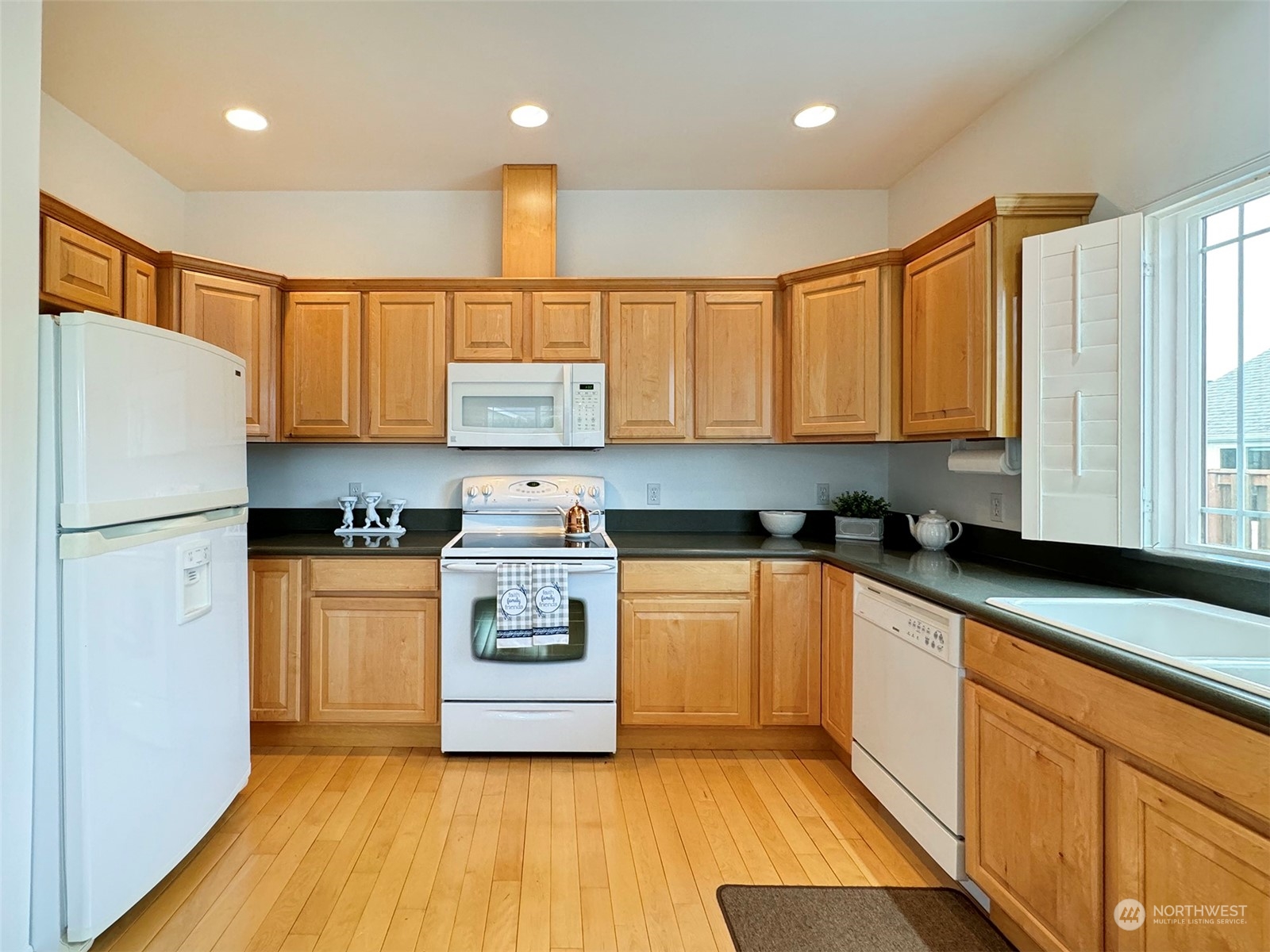 50 Nesting Place Sequim, WA 98382 - Photo 12 of 40 a kitchen with stainless steel appliances granite countertop a refrigerator sink and stove