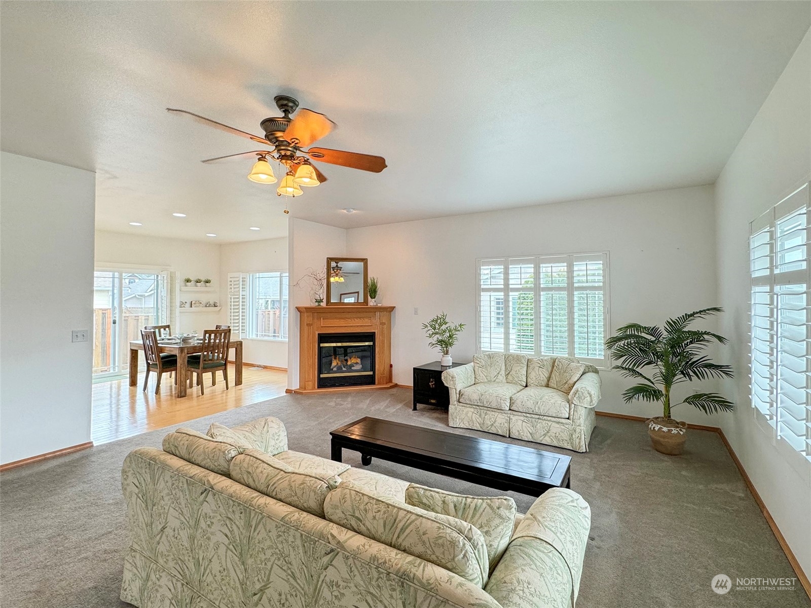 50 Nesting Place Sequim, WA 98382 - Photo 8 of 40 a living room with furniture a fireplace and a potted plant
