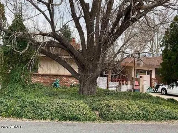 a view of house with outdoor space and garden