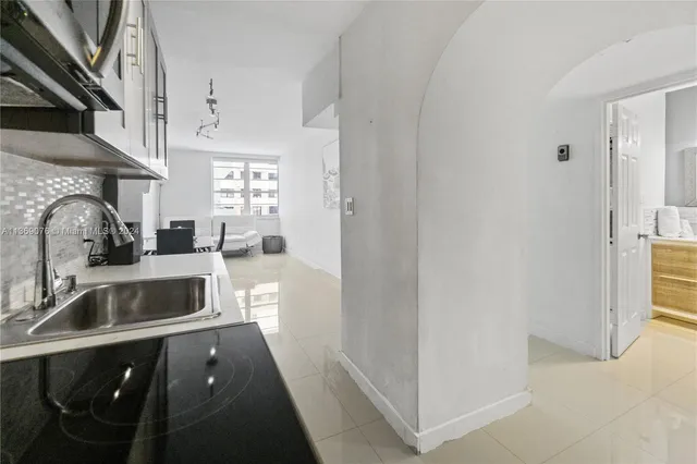 a kitchen with stainless steel appliances a sink and a refrigerator