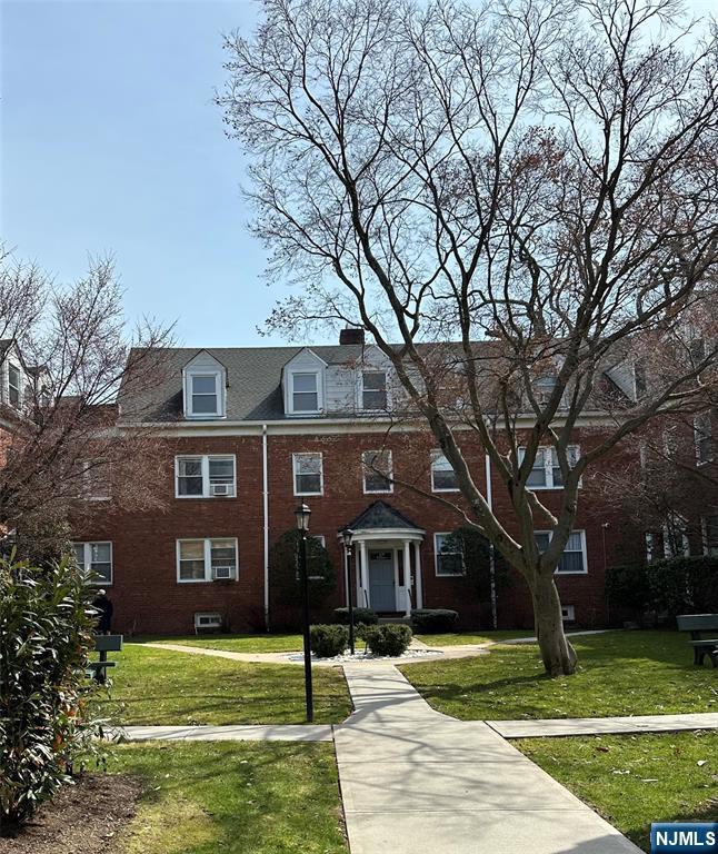 735 Elm Avenue, Unit 3E Teaneck, NJ 07666 - Photo 1 of 7 a front view of a house with a garden