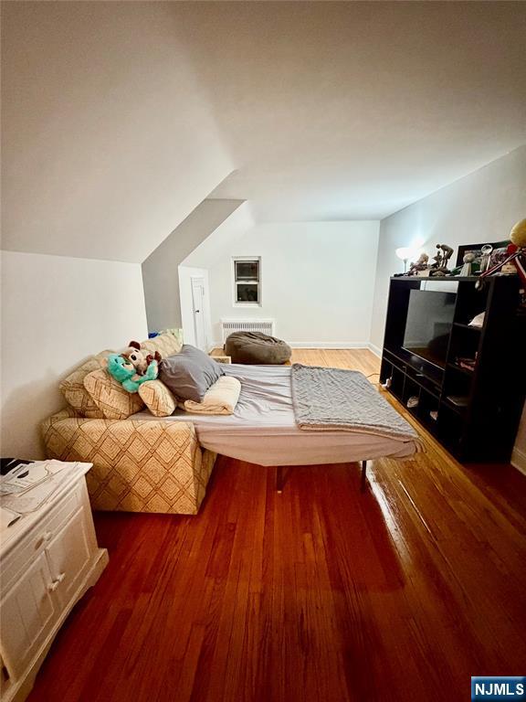 735 Elm Avenue, Unit 3E Teaneck, NJ 07666 - Photo 4 of 7 a bedroom with furniture and a wooden floor
