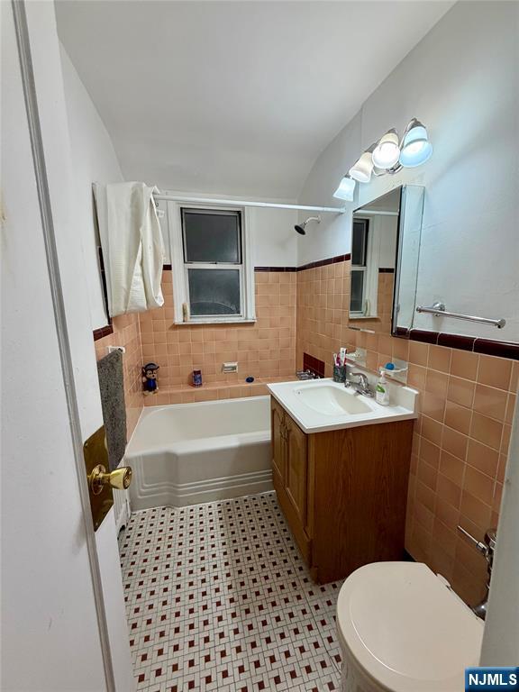 735 Elm Avenue, Unit 3E Teaneck, NJ 07666 - Photo 7 of 7 a bathroom with a sink a toilet and mirror