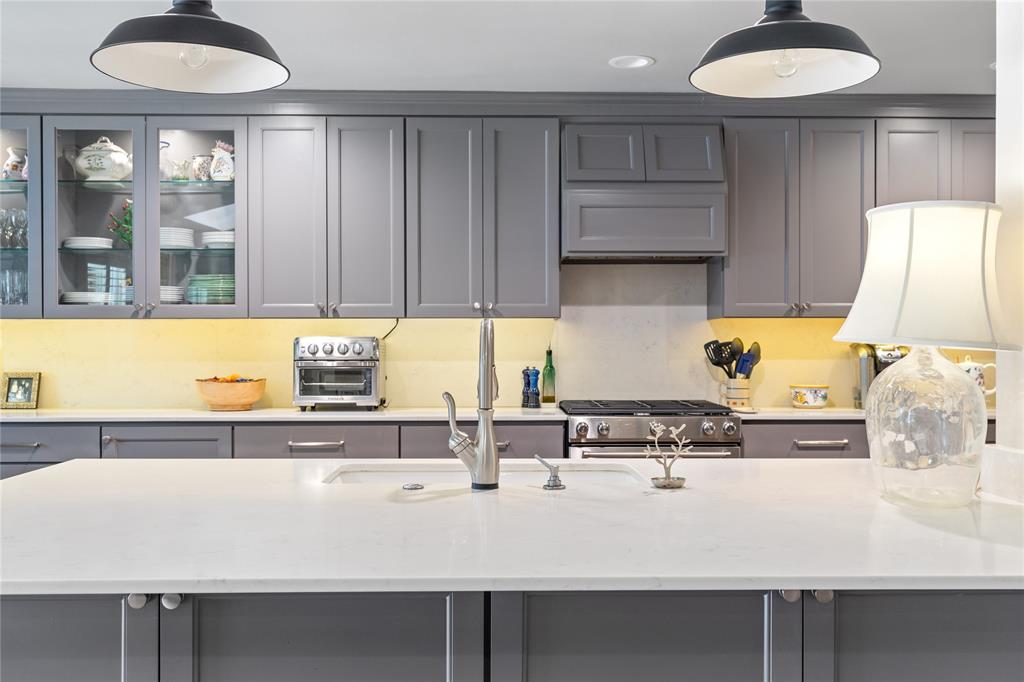 7138 Grand Oaks Road Dallas, TX 75230 - Photo 13 of 39 a kitchen with a sink a window and cabinets