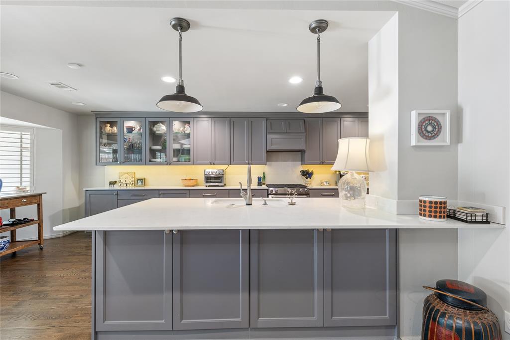 7138 Grand Oaks Road Dallas, TX 75230 - Photo 14 of 39 a view of a kitchen with granite countertop a sink cabinets and wooden floor