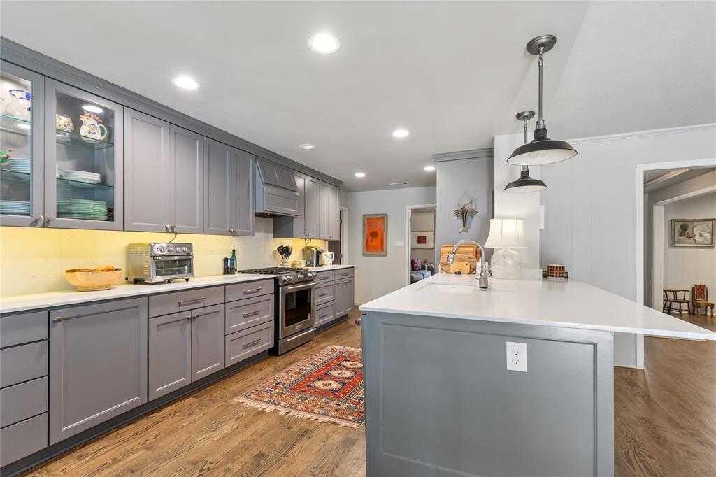 7138 Grand Oaks Road Dallas, TX 75230 - Photo 15 of 39 a large kitchen with sink a counter top space and appliances