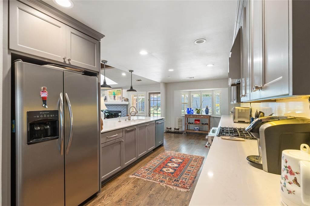 7138 Grand Oaks Road Dallas, TX 75230 - Photo 18 of 39 a kitchen with stainless steel appliances granite countertop a refrigerator a sink dishwasher a stove and a refrigerator