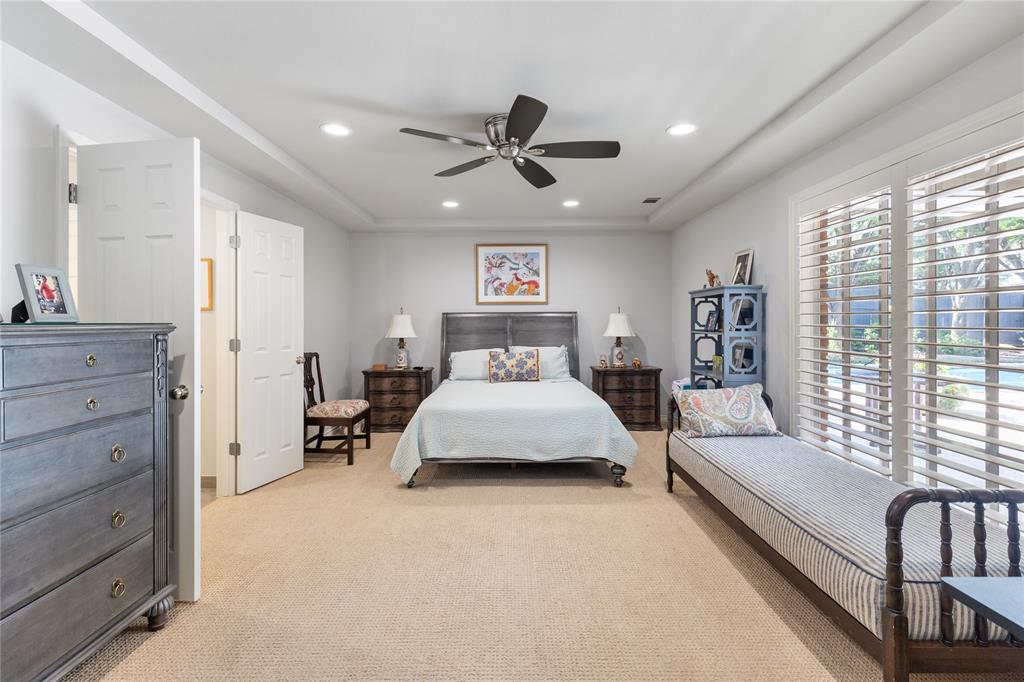 7138 Grand Oaks Road Dallas, TX 75230 - Photo 20 of 39 a spacious bedroom with a bed and window