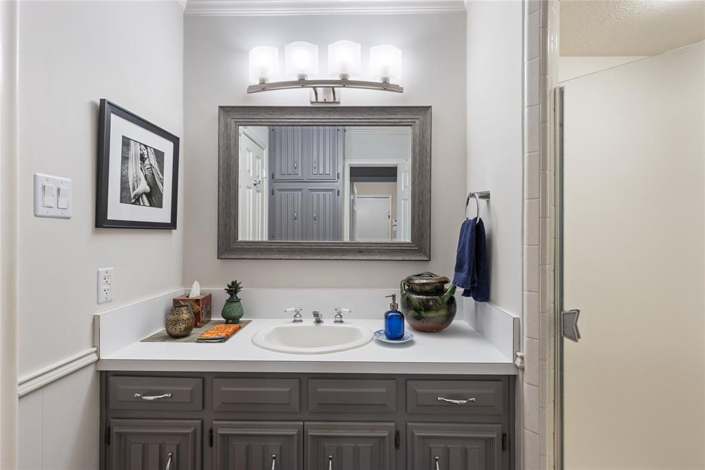 7138 Grand Oaks Road Dallas, TX 75230 - Photo 25 of 39 a kitchen with a sink and cabinets