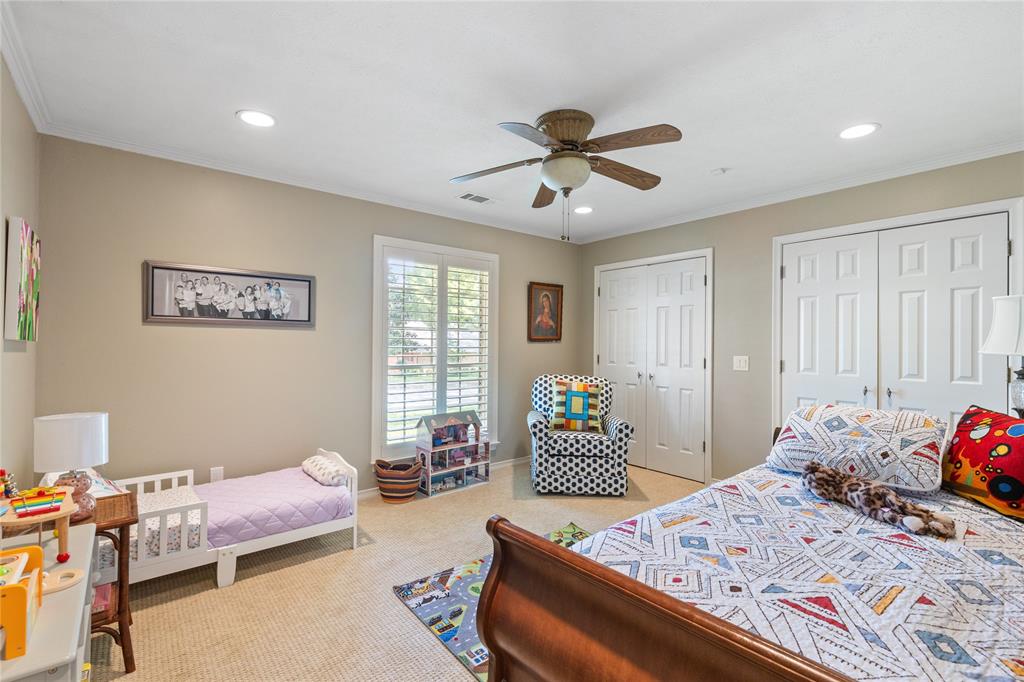 7138 Grand Oaks Road Dallas, TX 75230 - Photo 27 of 39 a bedroom with a bed and furniture