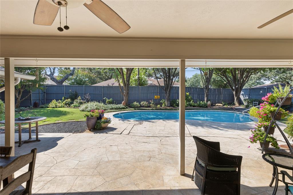 7138 Grand Oaks Road Dallas, TX 75230 - Photo 31 of 39 a view of a porch with furniture and garden