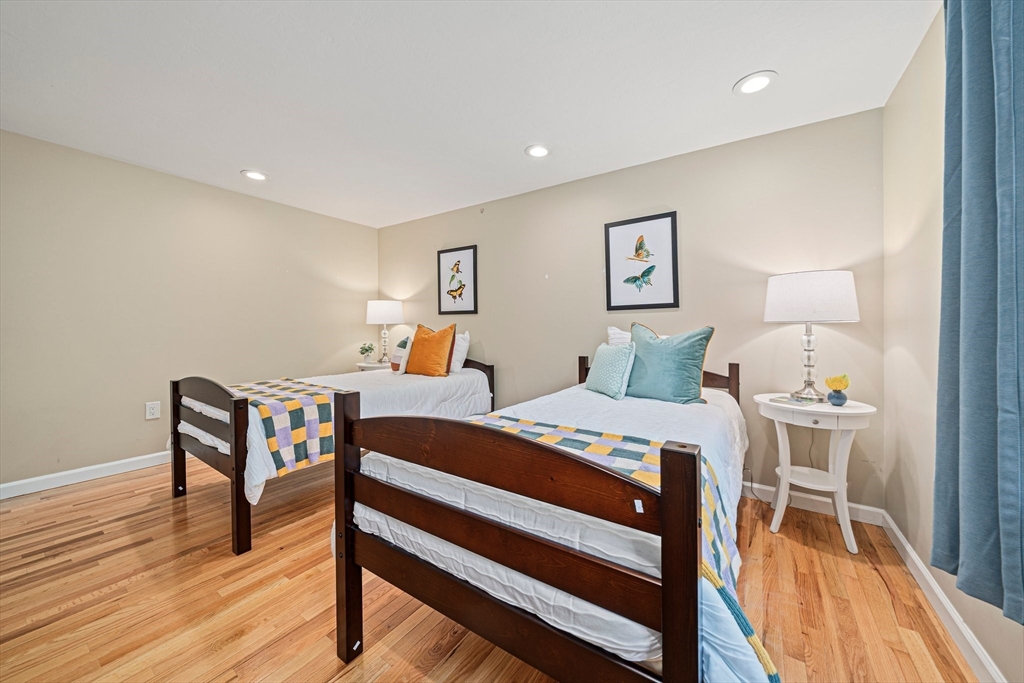 9 Powder Hill Way, Unit 9 Westborough, MA 01581 - Photo 14 of 40 a bedroom with a bed and a table in it