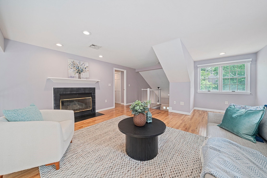 9 Powder Hill Way, Unit 9 Westborough, MA 01581 - Photo 15 of 40 a living room with furniture and a fireplace