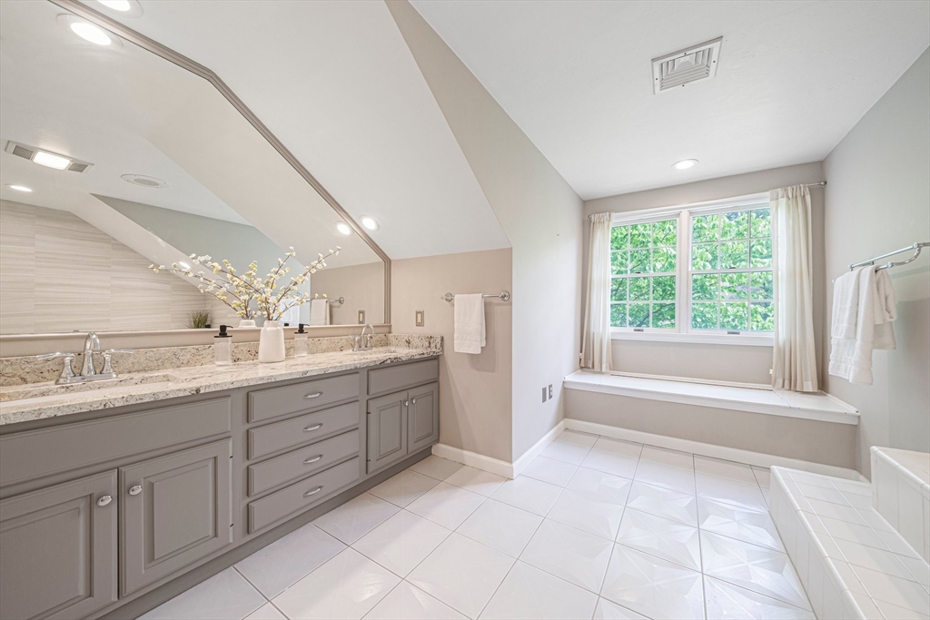 9 Powder Hill Way, Unit 9 Westborough, MA 01581 - Photo 19 of 40 a bathroom with a granite countertop sink mirror and a bathtub