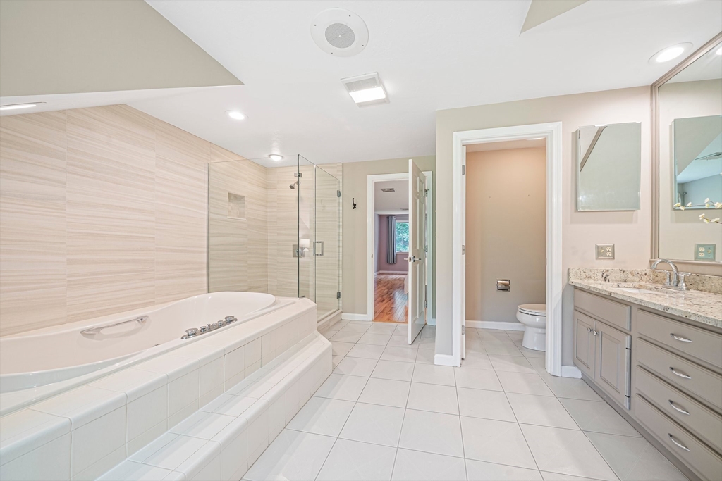 9 Powder Hill Way, Unit 9 Westborough, MA 01581 - Photo 20 of 40 a bathroom with a tub sink and mirror