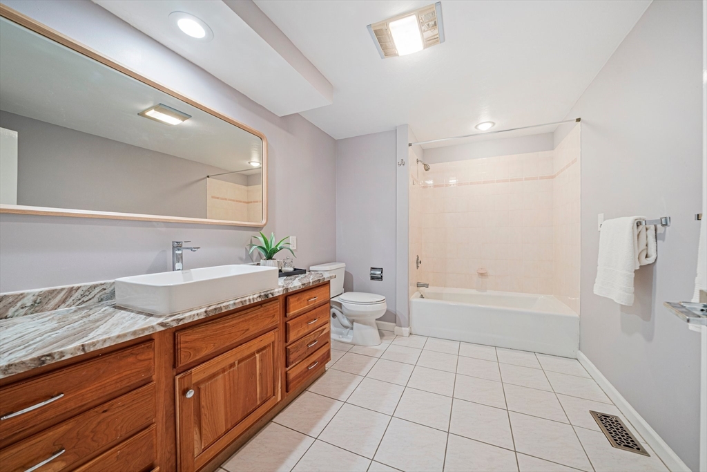9 Powder Hill Way, Unit 9 Westborough, MA 01581 - Photo 21 of 40 a spacious bathroom with a granite countertop sink a toilet mirror and bathtub