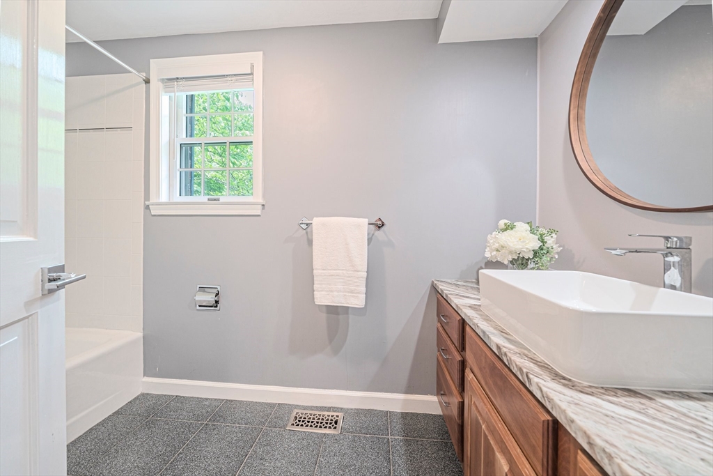 9 Powder Hill Way, Unit 9 Westborough, MA 01581 - Photo 22 of 40 a bathroom with a sink and a mirror