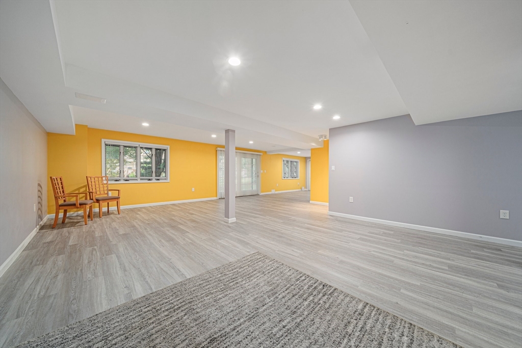 9 Powder Hill Way, Unit 9 Westborough, MA 01581 - Photo 26 of 40 a view of an empty room with wooden floor and a window