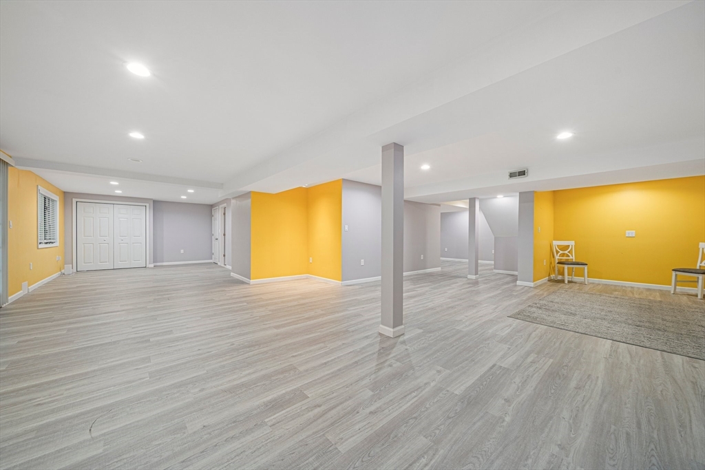 9 Powder Hill Way, Unit 9 Westborough, MA 01581 - Photo 27 of 40 a view of an empty room with wooden floor and a window