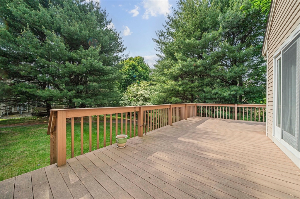 9 Powder Hill Way, Unit 9 Westborough, MA 01581 - Photo 29 of 40 a view of backyard with deck and garden