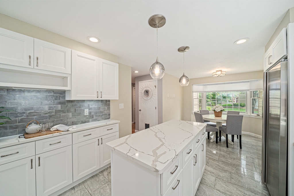 9 Powder Hill Way, Unit 9 Westborough, MA 01581 - Photo 3 of 40 a large kitchen with kitchen island white cabinets and stainless steel appliances
