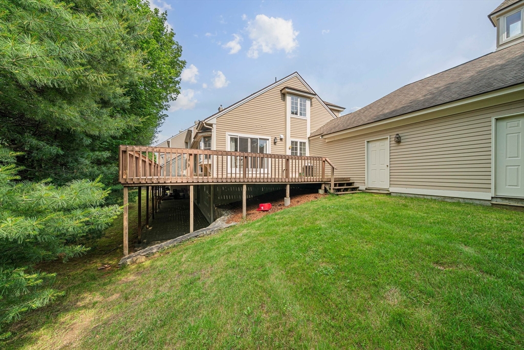 9 Powder Hill Way, Unit 9 Westborough, MA 01581 - Photo 32 of 40 a house view with a garden space