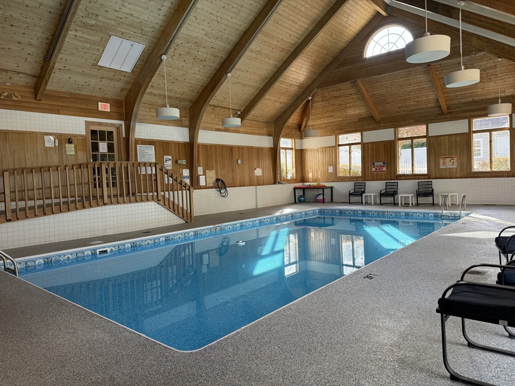 9 Powder Hill Way, Unit 9 Westborough, MA 01581 - Photo 37 of 40 a view of a swimming pool with an outdoor seating