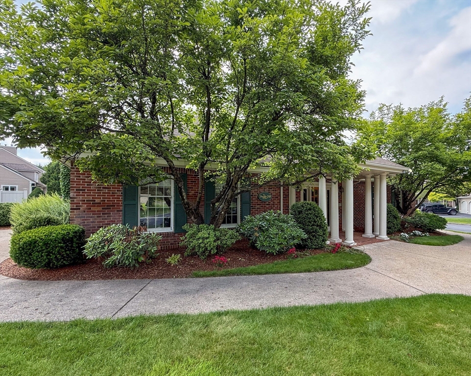 9 Powder Hill Way, Unit 9 Westborough, MA 01581 - Photo 39 of 40 a front view of a house with a yard and potted plants